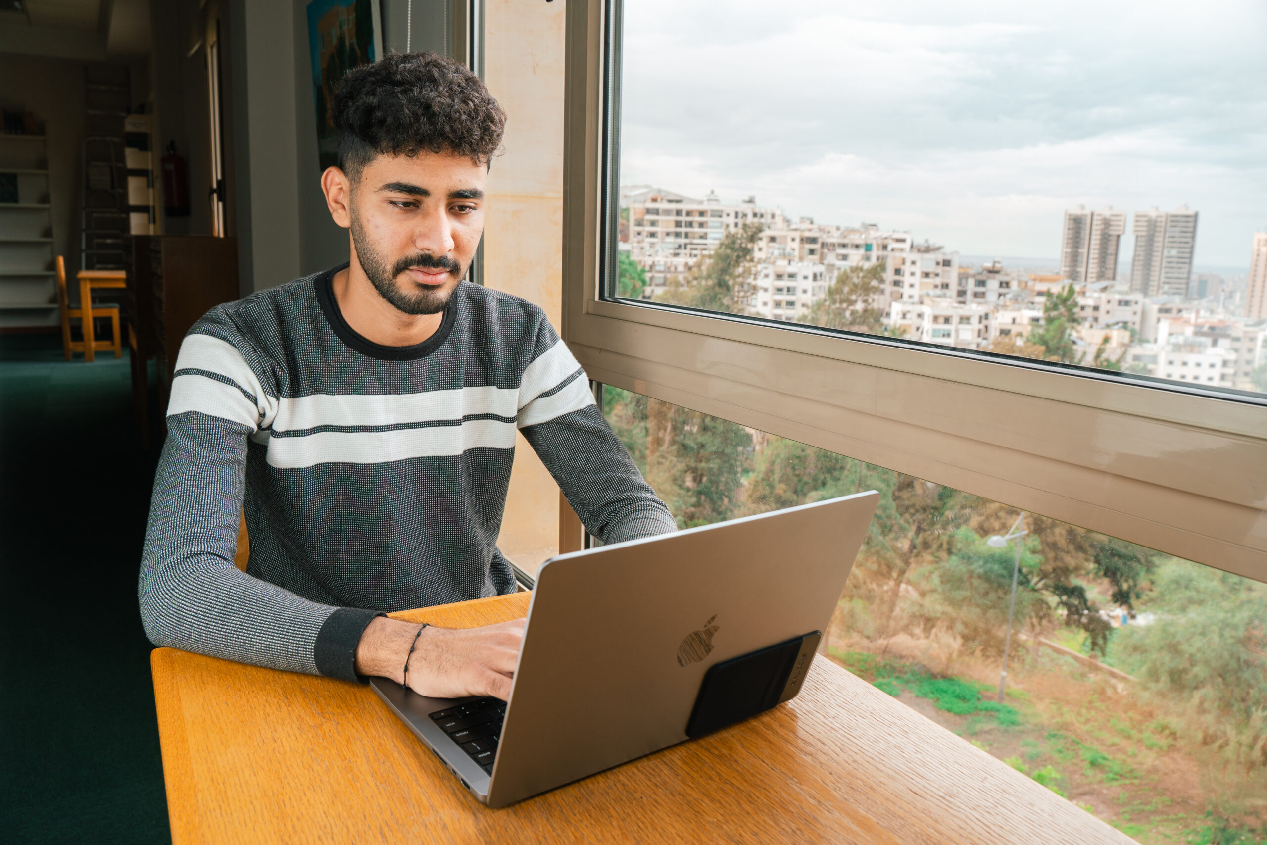 MEU student working with a laptop