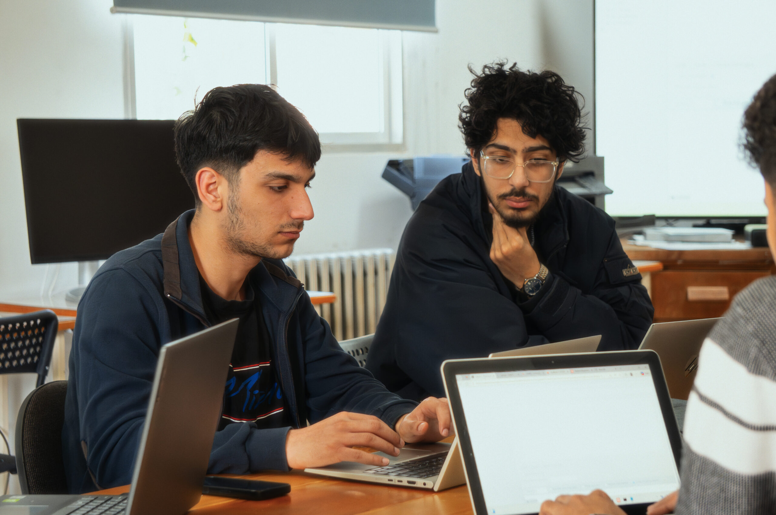 MEU students collaborating on a computing project
