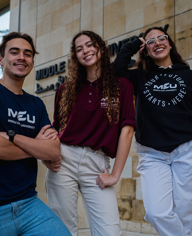 Middle East University students together in front of a campus building
